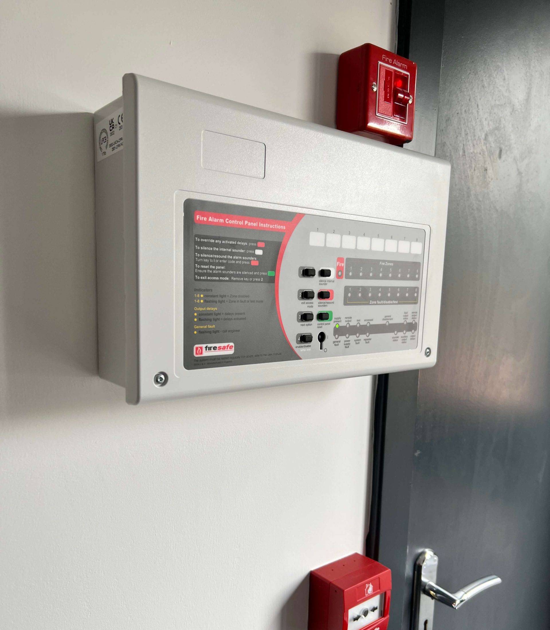 Fire Safety Engineer conducting maintenance on an electrical control panel